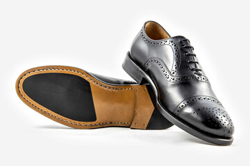Classic black leather shoes in a white background. 