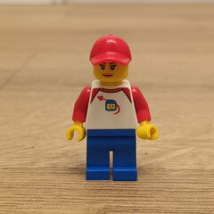 Naklejka premium Lego Minifigure - A Red Hat-Wearing Figure in a White Shirt and Blue Pants