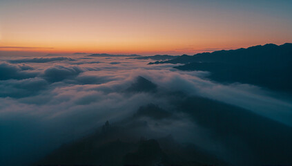 Peaceful Dawn Over Misty Mountain Landscape with Soft Clouds and Warm&ndash;Cool Morning Horizon