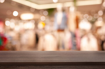 Empty wooden table in shop, blurred background. Space for design