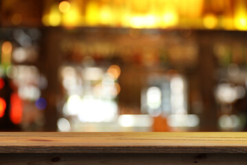Empty wooden table in bar, blurred background. Space for design