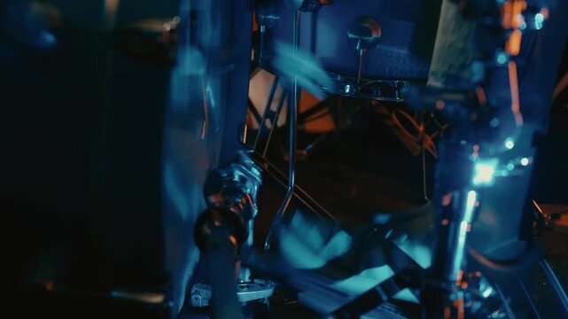 vivid closeup of drum mechanisms with industrial lighting emphasizing movement and metallic textures