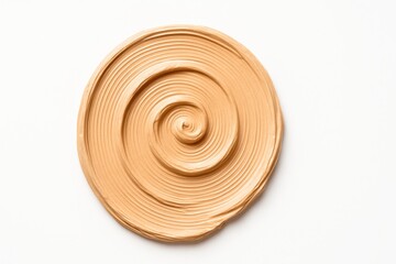 Makeup foundation swatch forming clean spiral on white background thick creamy texture ridged lines from palette knife for beauty cosmetic and skincare themes