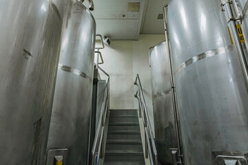 Stainless vertical steel tanks with pressure meter in equipment tank chemical cellar at the with scrolling wheel stainless steel