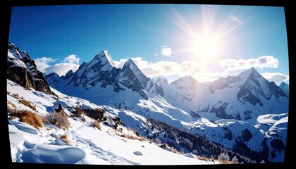 A breathtaking panoramic view of snow-covered mountain peaks bathed in bright sunlight, with a clear blue sky and a winding snowy path in the foreground.