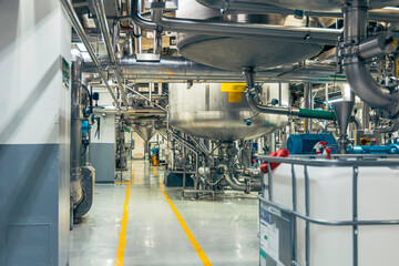 Stainless vertical steel tanks and pipes with pressure meter in equipment tank chemical cellar at the with stainless steel