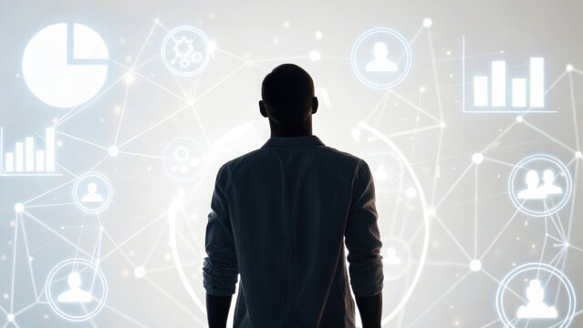 A silhouette of a person stands before a digital interface displaying graphs, charts, and icons, symbolizing data analysis and technology.