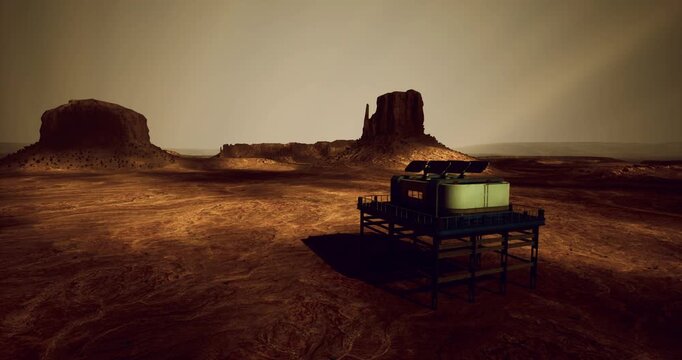 A futuristic base is stationed in an otherworldly landscape filled with rugged rock formations under a glowing sky during what appears to be sunset. The desolate terrain adds to the alien atmosphere.