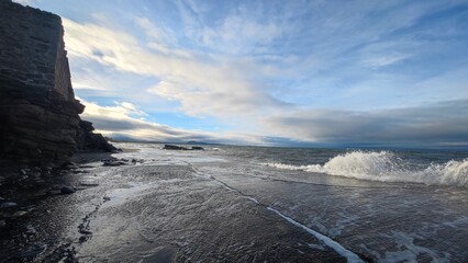 Waves crashing against a cliff