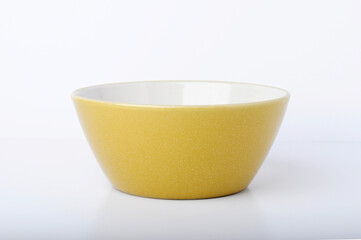 Small yellow bowl or dish single object on white background