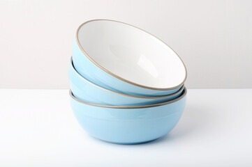 Stack of three Blue ceramic Bowls on white background