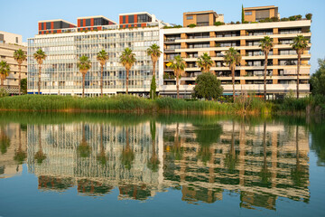 Contemporary architecture in Montpellier with waterfront residential buildings, greenery, reflection elements, urban landscape appeal and strong sustainable design focus