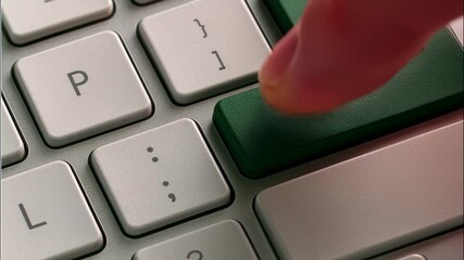 Finger pressing green keyboard key with Christmas tree symbol, representing digital holiday spirit and online celebration. Modern blend of tech and tradition — concept of virtual festivities, e-commer