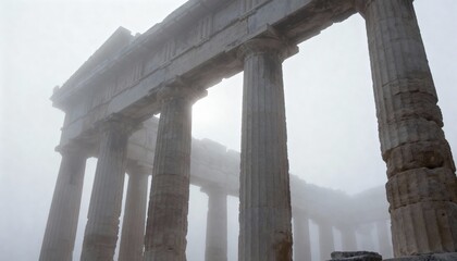 Ancient Greek temple ruins shrouded in mist.
