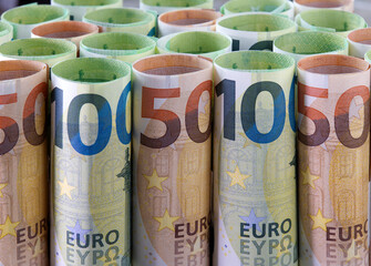 Rolls of euro banknotes as background.