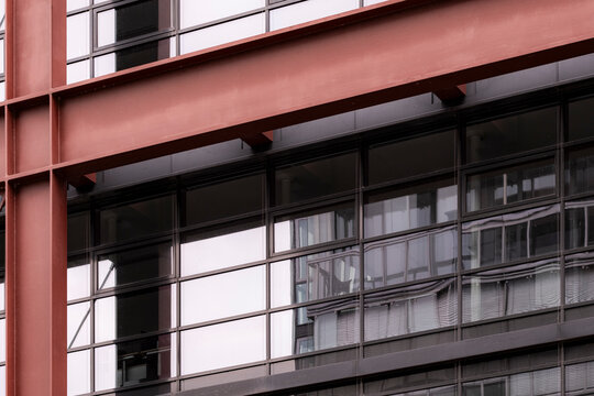 An architectural facade aesthetic presenting pattern, repetition and structure with minimalism and contrast, enhanced by a bold red module articulated through lines and refined clarity.