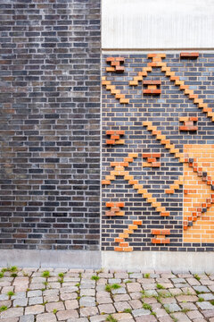 A commercial architecture facade study where symmetry, structure and minimalism intersect with geometry and contrast, incorporating a precise red panel, subtle texture and unified pattern.