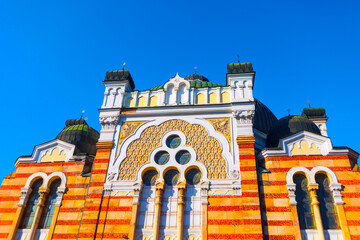 Ornate facade of Sofia Synagogue in Sofia, Bulgaria, elaborate blend of Moorish, Byzantine and Venetian architectural styles. Building with striped brickwork and central section with circular windows