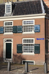 Amsterdam Oudekerksplein Street View with Old Brick Building Facade, Netherlands