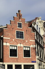 Noordermarkt House Facade with Stepped Gable and Street Sign in Amsterdam, Netherlands