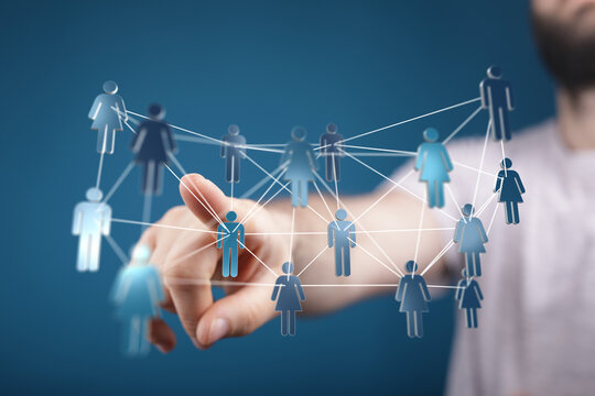 Hand interacting with digital network of people icons, representing connections, communication, and collaborati - Powered by Adobe