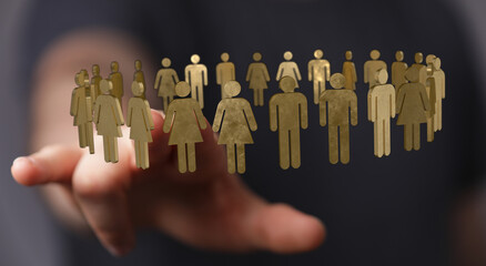 Abstract image of a hand holding golden figures symbolizing a team, community, or network. Perfect for illustrating concepts of collaboration, r