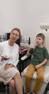 Female optometrist conducting visual acuity test for little patient