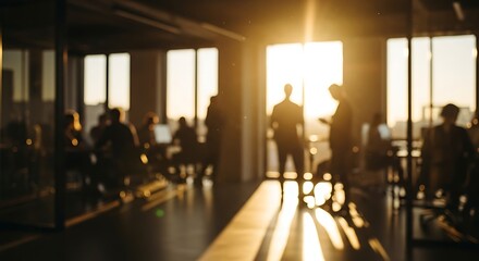 Business professionals in an open office space with warm sunlight