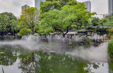 Zhongshan Park Classical Garden with Misty Pond and Modern Skyline View