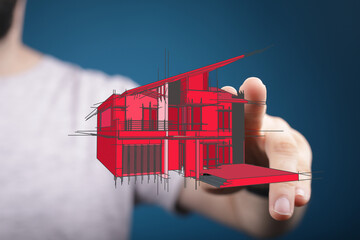 Hand holding a red house plan, real estate and building concepts. Architectural drawing, home...