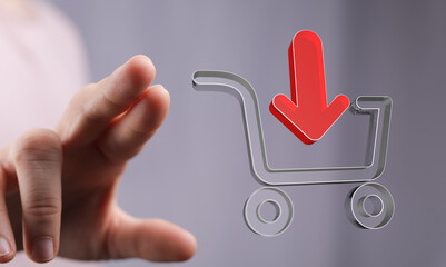 Person interacting with a shopping cart icon featuring a download arrow. Represents online...