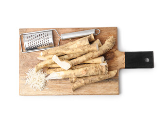 Grated horseradish, grater and roots isolated on white, top view