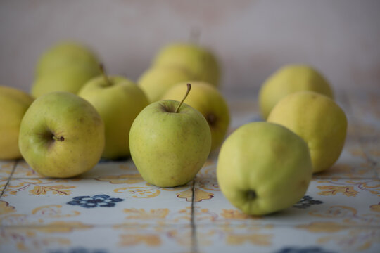 Whole yellow apples on tiled surface, useful for recipe banners, food packaging visuals and natural produce campaigns. - Powered by Adobe