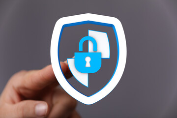 Concept of cybersecurity, data protection, privacy, and online safety represented by a hand holding...