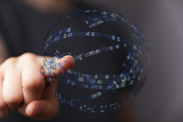 Close-up of a hand touching a digital globe with binary code, symbolizing technology, innovation, and network connection. Ideal for d