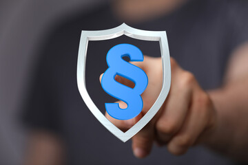 Conceptual image representing law and order. A hand touches a shield with a legal symbol, symbolizing protection, defense, and justice. Perfect