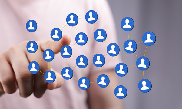 Abstract image of hand touching a network of connected people icons. Represents social media, communication and - Powered by Adobe