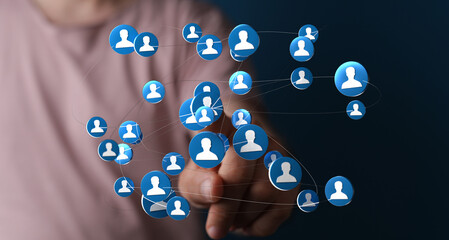 Hand reaching out to connected network of people icons, representing social networking, global communication and teamwork.  Ideal for business,