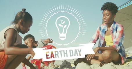 Building family sculpting sandcastles at beach shoreline, Earth Day banner, adult wearing plaid top