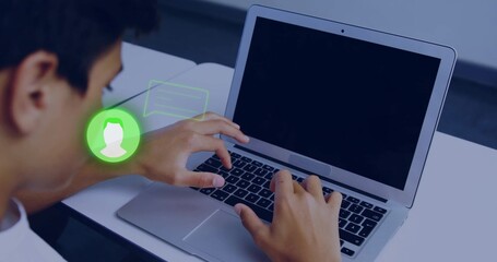 Typing teenage male in white shirt working on silver laptop at study table, green chat overlay