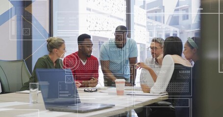 Leaning teammates discussing project in casual business attire in office meeting room, with laptop