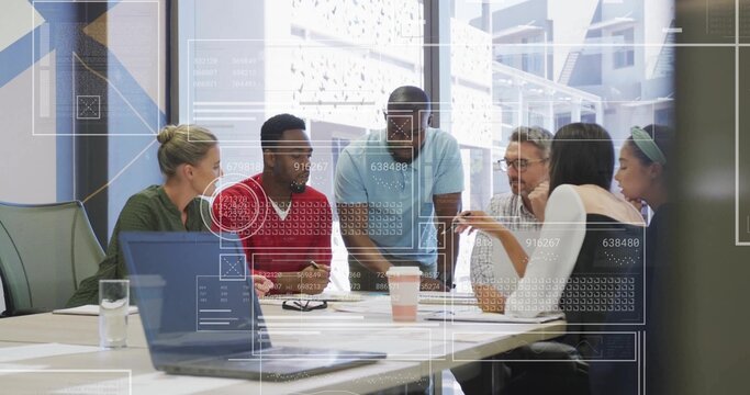 Leaning teammates discussing project in casual business attire in office meeting room, with laptop