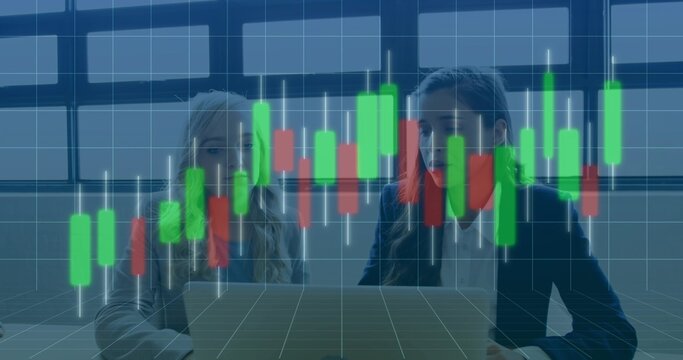 Analyzing three colleagues in blazers examining candlestick chart in office with laptop on table