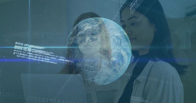 Standing women studying laptop in office, blouse, light blazer, viewing AR globe and binary code - Powered by Adobe