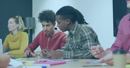 Sorting two men in red sweater and green plaid arranging index cards at table, sticky notes