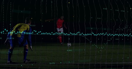 Kicking red kit player approaching soccer ball on night pitch with goal net, teal analytics overlay