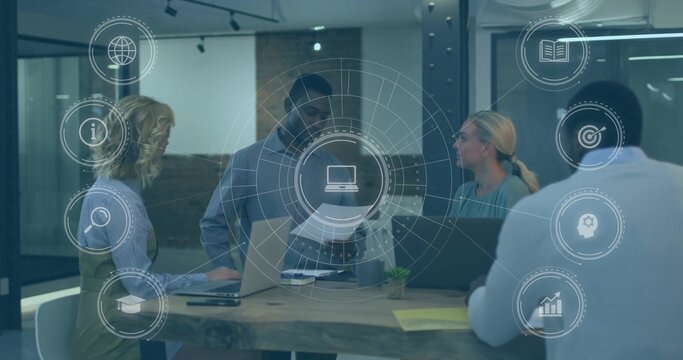 Discussing team in blazers reviewing documents at modern meeting area with laptops and AR overlay