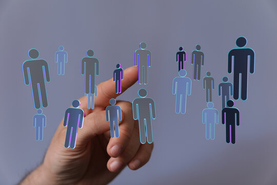 Hand pointing at digital people icons representing connection, teamwork, and networking in technology.
