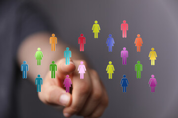 Hand pointing at colorful people icons representing community, teamwork, and unity. Illustrating connection and collaboration in a digital envir