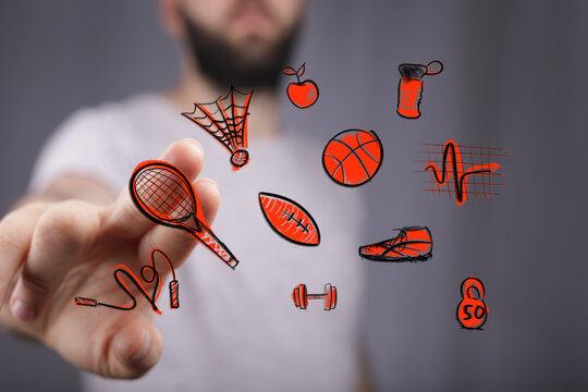 Engaging with digital health and fitness. A hand interacts with interactive virtual sports icons, representing modern wellness technology and ac